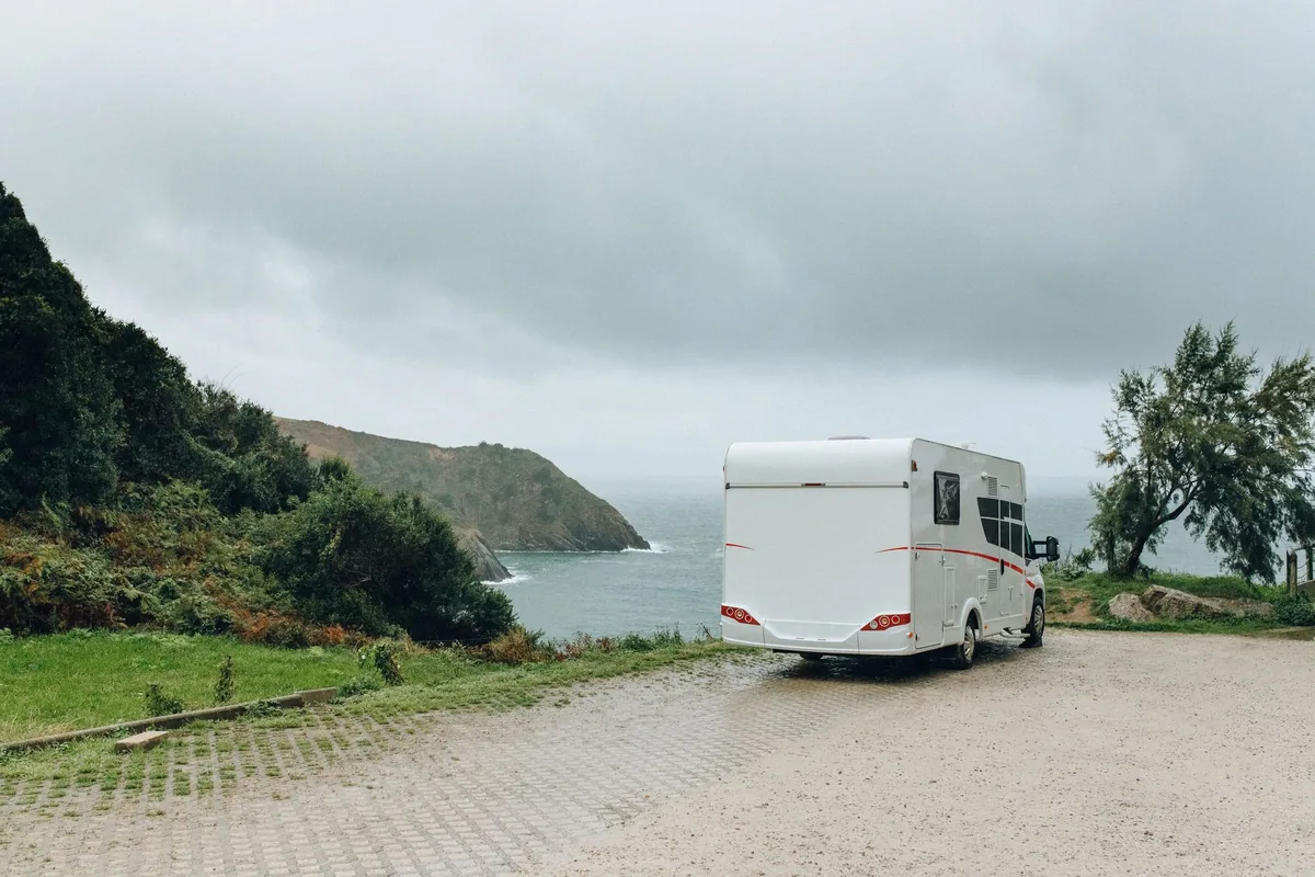 A travel trailer parked on a bluff overlooking the coastline